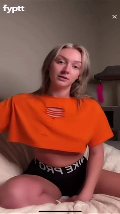 Twenty year old thot keep showing pierced nips slips under her orange croptop on TikTok
