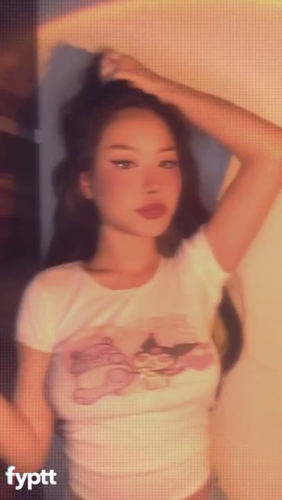 Pretty petite Asian babe shows her cute tits on TikTok photo