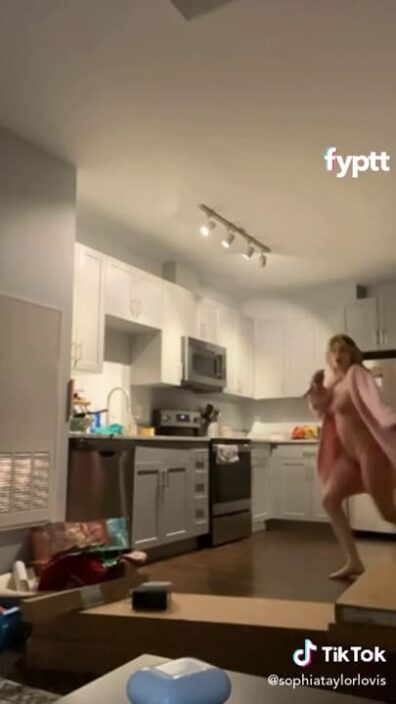 This girl is so happy that she's dancing naked on TikTok in the kitchen