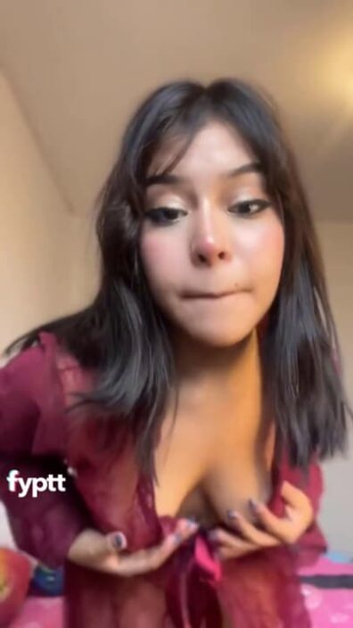 Naughty brunette Latina teasing with her tits and ass in a red sheer dress on NSFW TikTok