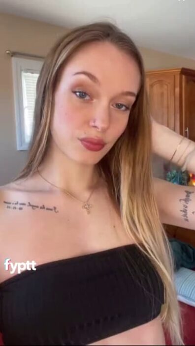 Slim long haired girl making a NSFW TikTok with her new black swimsuit