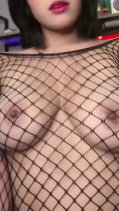 Young short hair brunette makes her tits look sexier with a fishnet shirt