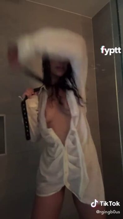 Brunette petite in wet white shirt dancing with a belt under the shower NSFW TikTok