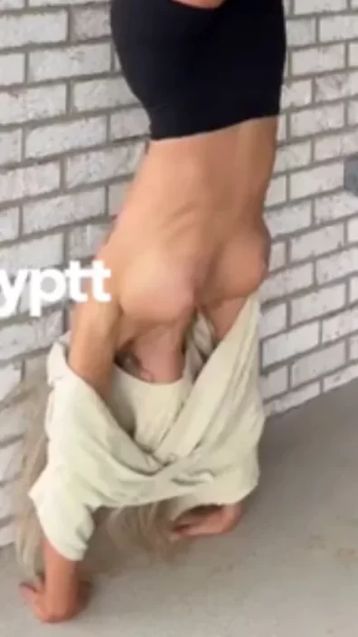 Playful athletic vibe in black biker shorts while her loose t-shirt revealing tits looks so hot